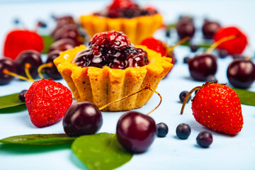 Small berry cake and ripe berries