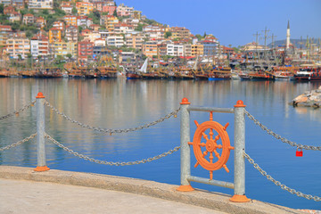 The embankment of the city of Alanya with a fence in the form of a ship's steering wheel.