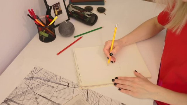 Close up girl draws a pencil on paper. Female fashion designer drawing sketches the dress. Fashion designer drawing and paint. Study design tutorial animator illustrator work freelance session wedding