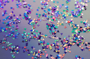 Abstract background of multicolored confetti in neon light.