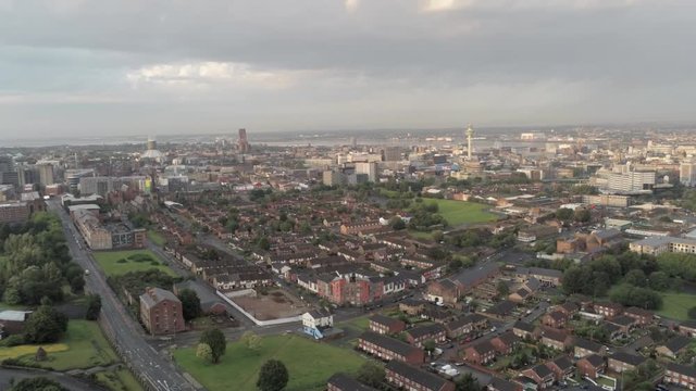 Aerial cityscape across Liverpool city buildings, cathedral, radio city tower along skyline. Dolly right.