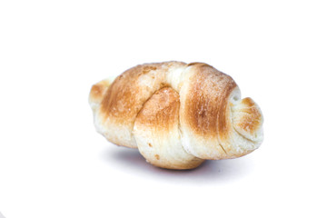 small juicy croissant isolated on white background.