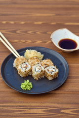 Plate with japanese rolls, ginger, wasabi and chopsticks