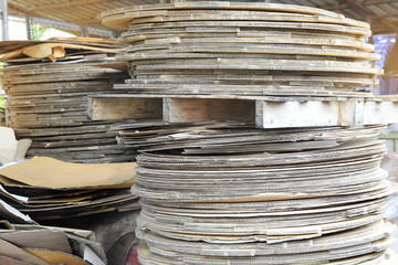 Collected area of used scrap cardboard paper and wood pallets from general waste management industry.