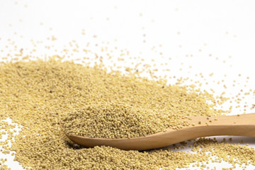 Organic Healthy millet in spoon isolate on white background.
