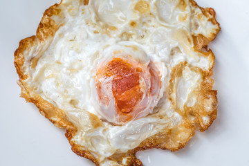 A fried egg (salted egg) for breakfast on white background.