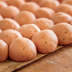 close up finished pink dough in the bakery on wooden table. Working process. Private bakery. Production of bread.