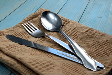 Cutlery spoon, fork, knife lie on the table