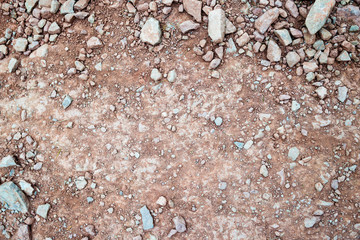 reddish soil and small stones - with empty space in the middle - for background
