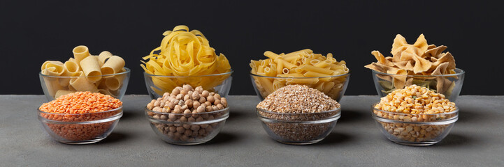 Set of grains and pasta in glass plates on black