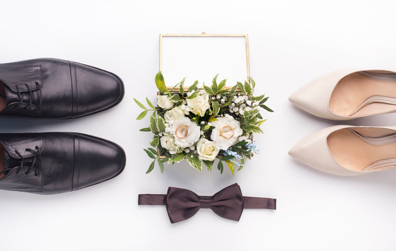 Wedding shoes and bouquet on white background
