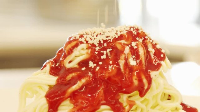 Sprinkling Yellow Crumble Over Spaghetti Ice Cream