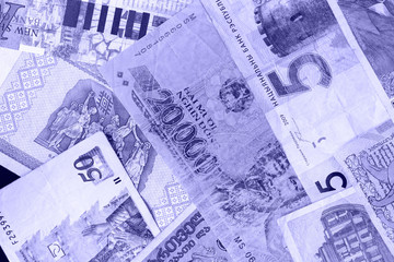 Fototapeta premium Various banknotes from different countries close-up (Belarusian rubles, Georgian lari, Polish zloty, Israeli shekels, Vietnamese dongs). Money background blue color toned