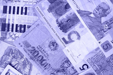 Various banknotes from different countries close-up (Belarusian rubles, Georgian lari, Polish zloty, Israeli shekels, Vietnamese dongs). Money background blue color toned