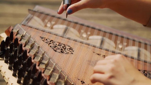 Close Up Womans Hand Playing Zither Instrument
