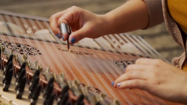 Womans Hand Playing Zither Instrument