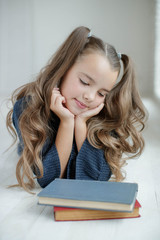 Teen girl reading a book. School fashion. 