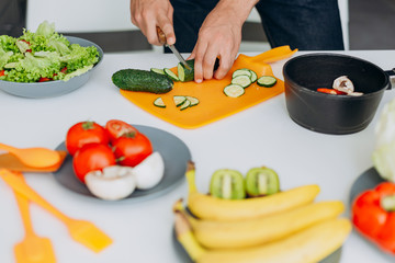 Closeup male hands holding a vegetable during prepared healthy food