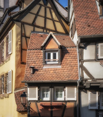 View of the roofs of the beautiful city of Colmar, Alsace, France and its colorful half-timbered houses. This beautiful yellow house in Petite Venise