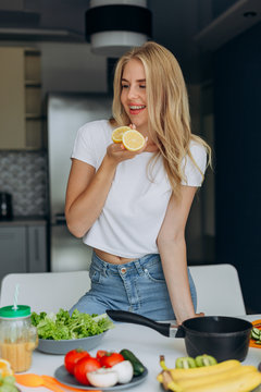 Portrait of happy woman at the table with a healthy food. - Image