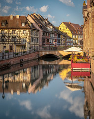 Flanked by colourful half-timbered fishermen's houses, the Quai de la Poissonnerie runs alongside the Lauch River. Colmar, Alsace, France in the Petite Venise area.