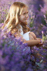 A child in a field with flowers. Teen girl in a lavender field. Happy child in nature. 