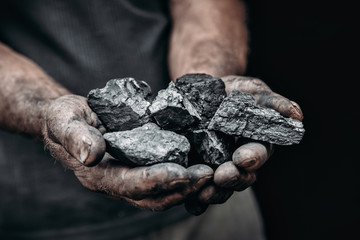 Coal in miner holds. Concept industry mining