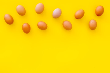 Fresh eggs for organic food on yellow background top view mockup