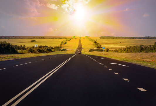 Car Traffic on a multi-lane country highway at sunset - Powered by Adobe