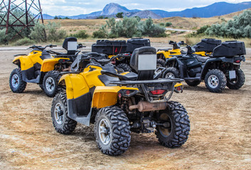 Fototapeta na wymiar ATVs in the parking lot in the field