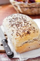 Homemade wheat bread with flax seeds on a kitchen table