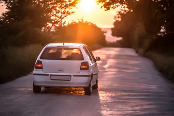 Fototapeta na wymiar car moves on a highway at sunset