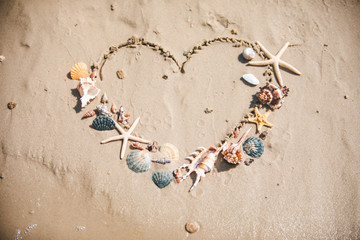 Naklejka na ściany i meble view of drawn love heart symbol on sand beach