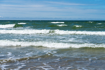 Seaside. A wave is coming. Small grains of sand close up. Concept. Background. Summer is over. Summer sales. Free space for text.