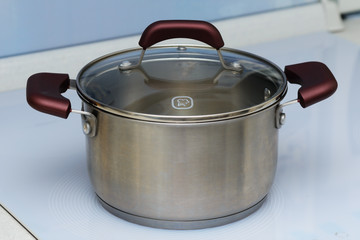 stainless steel pan on white induction hob