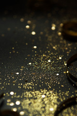 Golden sparkles and ribbons on black background. Festive concept. - Image