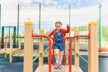 Active little girl on playground