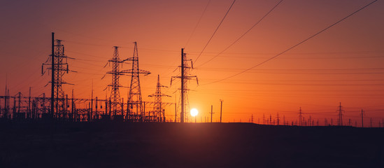 Sunset, against the background of power station, wires, horizon