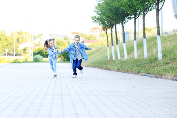 Children run holding hands. The concept of childhood, family, education.