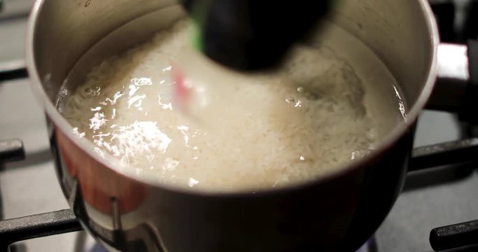 Water boils on the stove and boil rice there