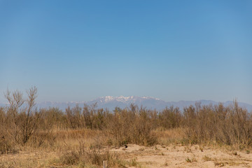 Landscape shot with far snowy mountain with clear sky