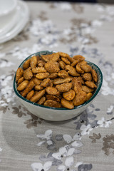 Toasted almonds on a bowl on a table with floral black and white decoration