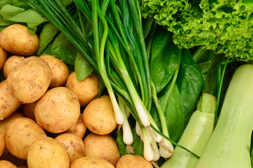 Fresh green vegetables and herbs as a background.