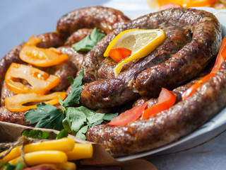 Grilled sausage with greens, lemon and vegetables