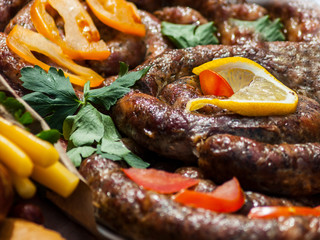 Grilled sausage with greens, lemon and vegetables