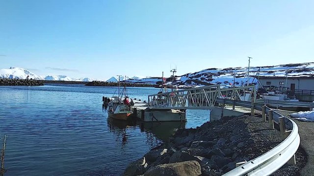 boats and sailboats stand in the winter harbor. snow. zisa. snowy mountains.