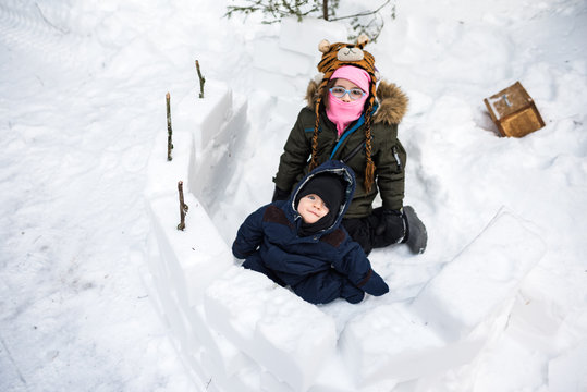 Building Snow Fort And Bundled Up