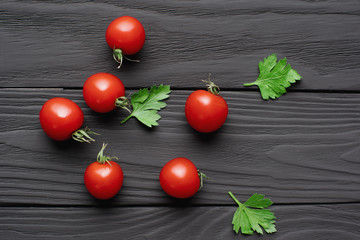 red cherry tomatoes and green parsley leaves