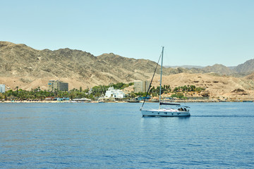 Fototapeta na wymiar View from the luxury yacht to the Red Sea. Hotels for tourists, boats and yachts for a holiday.