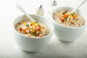 Homemade chowder soup in white bowls